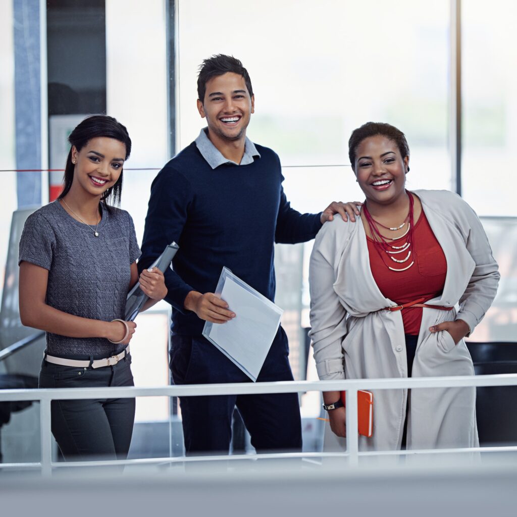 Portrait of a group of smiling colleagues working together in an office