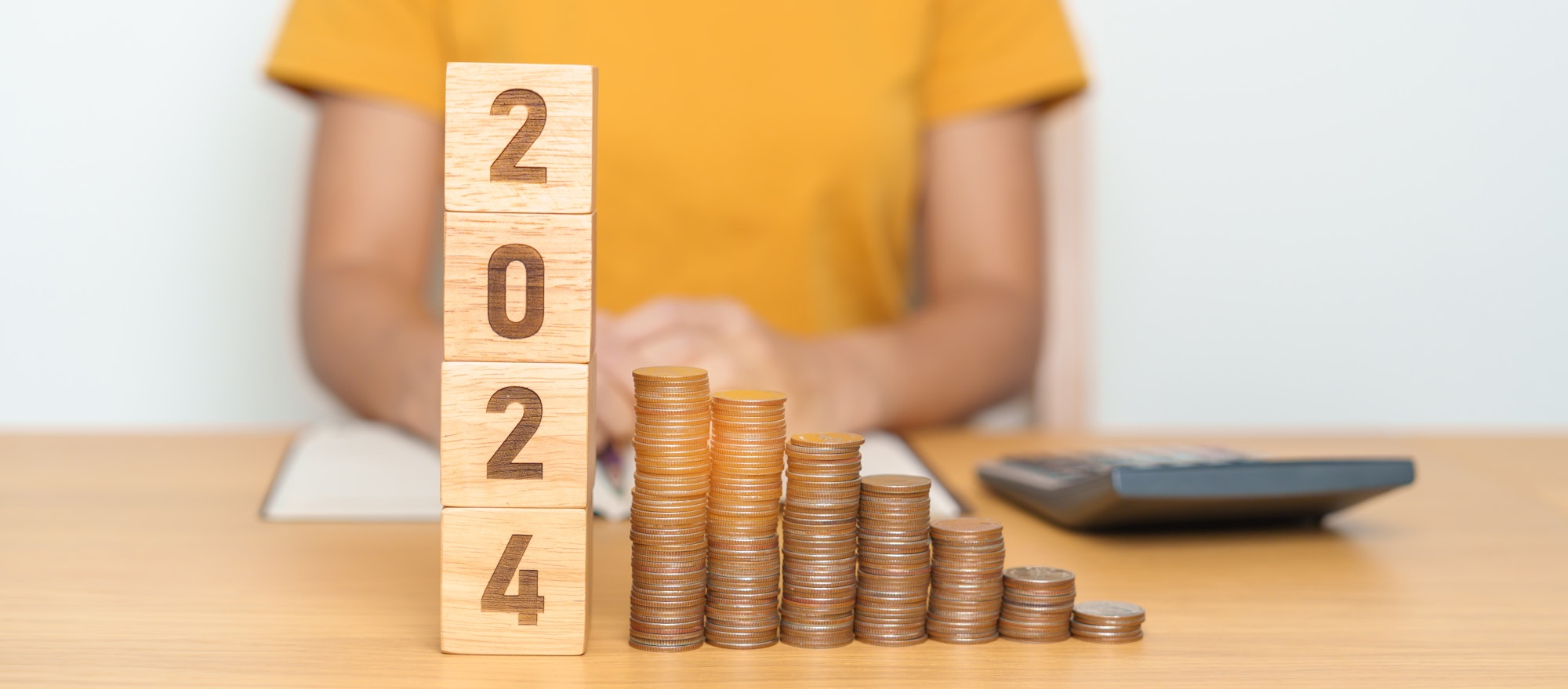 2024 year block with Coins stack. investment, financial, savings and New Year Resolution concepts